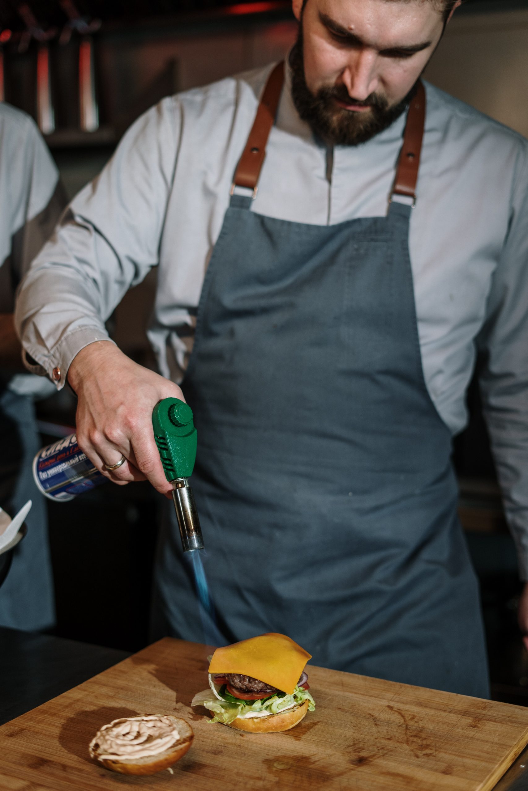 man-in-white-dress-shirt-holding-green-and-silver-hand-tool-4253712