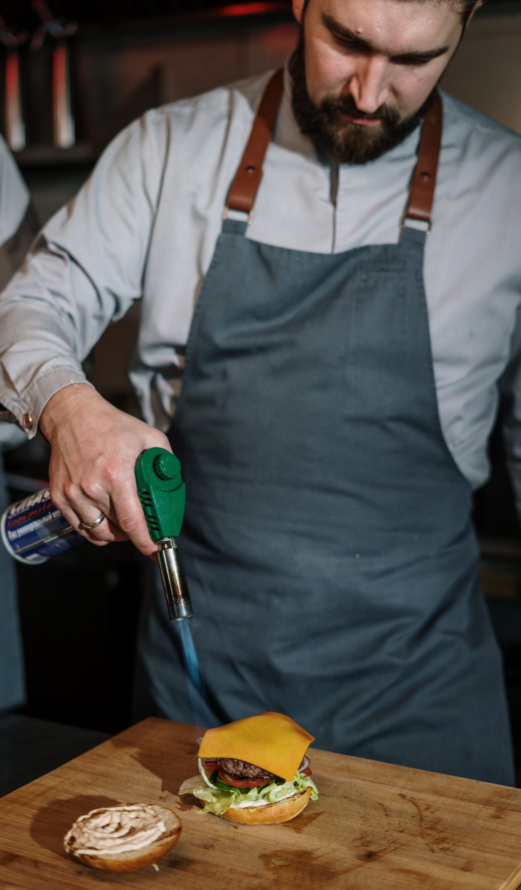 man-in-white-dress-shirt-holding-green-and-silver-hand-tool-4253712